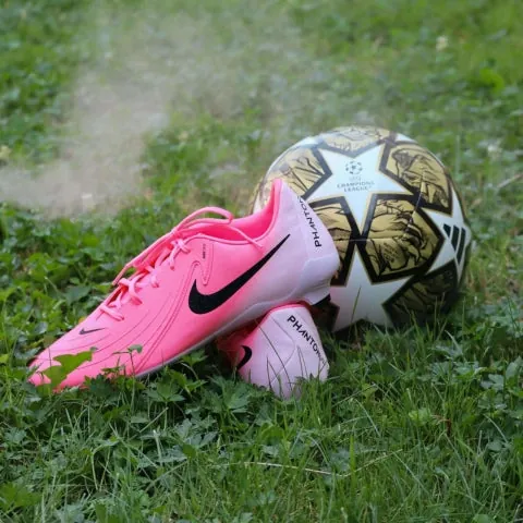 soccer cleats, and ball on grass field